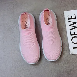 Detailed top-down view of pink fly-knit women's sneakers with breathable mesh upper