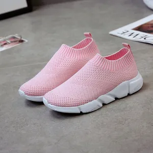 Close-up of women's pink breathable knit sneakers with white slip-resistant thick soles