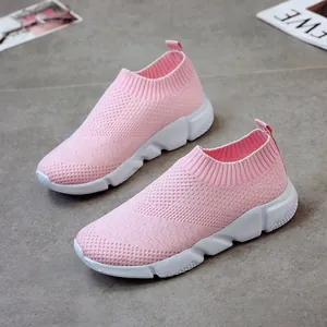 Close-up view of pink breathable knit sneakers featuring a comfortable white chunky sole