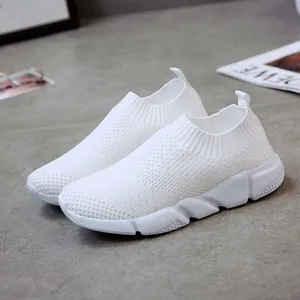 Minimalist breathable white flyknit slip-on sneakers for women with textured soles