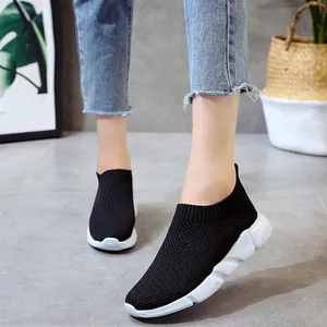 Breathable black knitted slip-on sneakers for women with stylish chunky white soles
