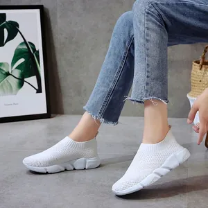 Breathable white knit slip-on sneakers for women in a casual indoor lifestyle scene
