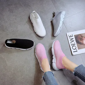 Detail of breathable fly-knit sneakers in various colors including pink and white