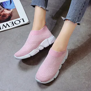 Close-up of pink breathable knit slip-on sneakers for women with white chunky sole