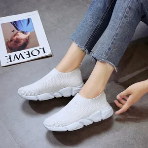 Comfortable white breathable fly-knit slip-on sneakers for women, casual lifestyle scene