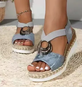 Stylish women's blue snakeskin wedge sandals with silver metal ring and rope platform.