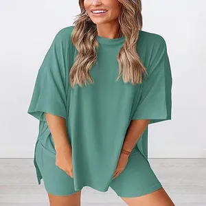 Close-up of women's oversized teal loungewear set with side slit details