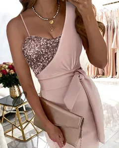 Detailed view of pink sequined evening dress with one-shoulder design and waist tie.