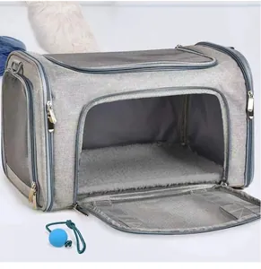 Detail view of gray breathable pet carrier featuring plush mat and blue toy accessory