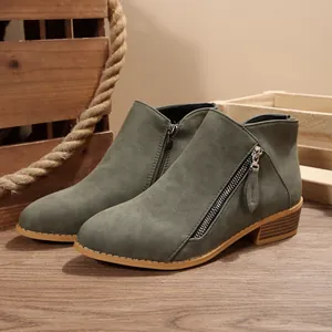 Detailed side view of olive green pointed toe ankle boots with chunky heel