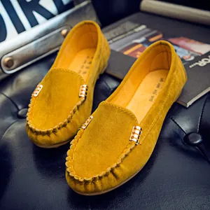 Classic yellow suede loafers with gold metal buckle and round toe design