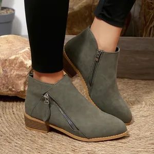 Detailed view of women's olive green chunky heel ankle boots with side zipper