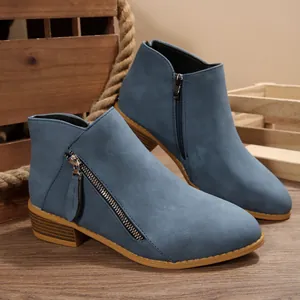 Close-up of blue faux suede pointed toe ankle boots with side zipper and chunky heel