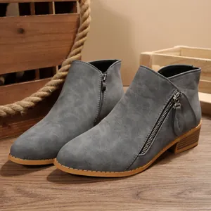 Close-up of grey chunky heel pointed toe ankle boots with metallic side zipper