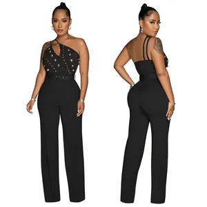 Detailed view of black one-shoulder jumpsuit with golden studs and a belted waist