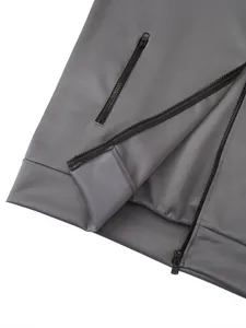 Detail of grey sports jacket featuring high-quality zipper and pocket stitching