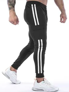 Close-up detail of black men's athletic joggers with cargo pockets and white stripes