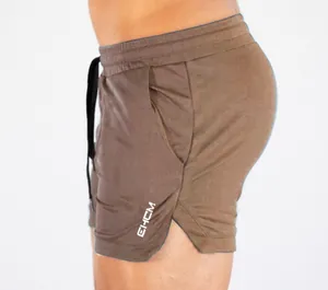 Side view detail showing the mesh texture and logo of brown quick-dry sports shorts for men