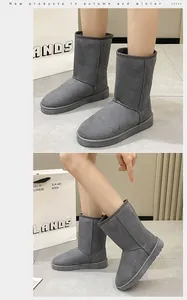 Detailed view of grey suede mid-calf snow boots showing warm lining and sturdy soles