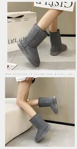 Classic grey high-top snow boots for women, stylish winter cotton footwear shown on model.