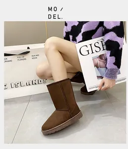 Macro view of brown suede-like snow boots for women showing durable rubber sole and stitching