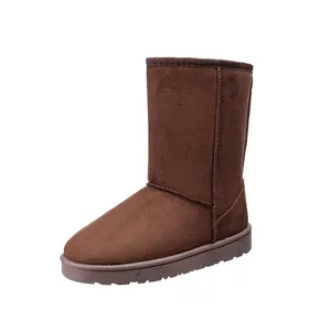 High-angle detailed shot of classic chocolate brown suede snow boots for winter.