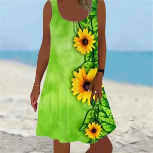 Sleeveless green summer dress with vibrant sunflower print pattern on beach background