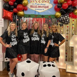 Five women in black sequined 'It's My Birthday' party dresses in festive setting