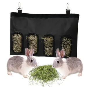 Black hanging rabbit hay feeder bag with 4 holes for small pets like guinea pigs.