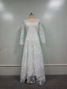 Full length detailed view of a white long-sleeved lace wedding dress with floral embroidery