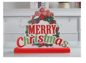 Close-up of a festive wooden Merry Christmas tabletop sign with glitter accents
