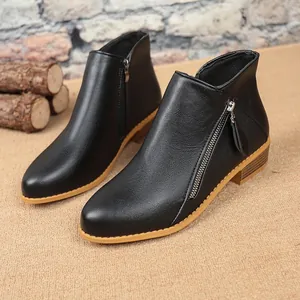 Detailed side view of elegant black faux leather women's ankle boots with zipper accents