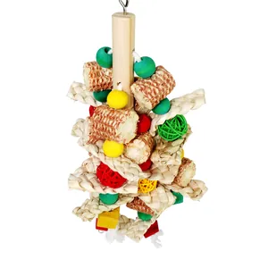 Close-up detail of parrot toy featuring natural corn cobs and colorful straw braids