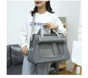 Model carrying a grey breathable large capacity portable cat carrier with mesh ventilation detail