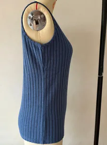 Detailed side view showing the texture of a blue wide-ribbed sleeveless knit tank top