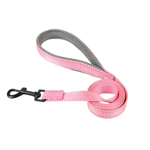 Close-up detail of a pink reflective dog leash featuring a grey padded mesh handle for comfort