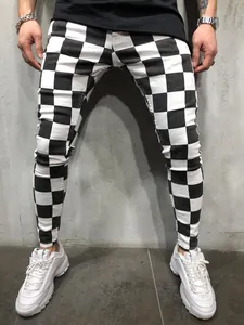 Detail view showing the black and white checkerboard pattern on men's slim fit trousers