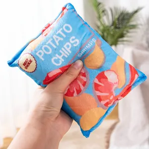 Soft plush squeaky potato chip pet toy shown held in hand for size and texture reference.