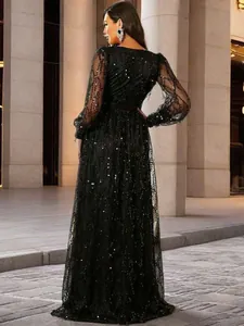 Detailed back view of an elegant black sequined mesh evening gown with long sleeves.