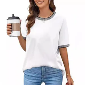 Close-up view of a white short sleeve t-shirt with textured trim on collar and cuffs