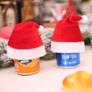 Mini red velvet Christmas hats with white pom-poms for festive holiday decorations.