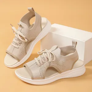 Detail view of breathable beige fly-knit platform sports sandals for summer comfort