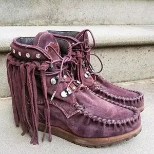 Detailed view of purple suede fringe ankle boots with silver studs and durable thick soles