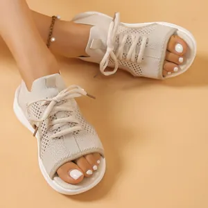 Detailed view of beige knit open-toe sporty sandals with lace-up design and thick sole
