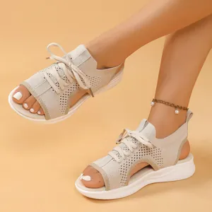 Detailed view of women's beige knit sport sandals with breathable mesh and thick sole.