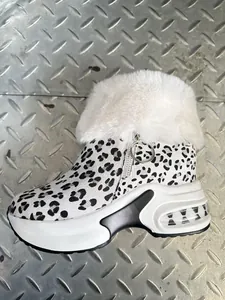Detailed side view of leopard print snow boots with white fur collar and platform sole