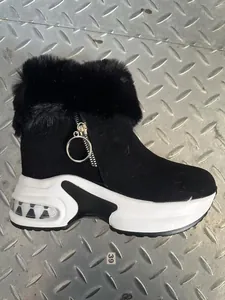 Side view showing the thick platform sole and faux fur trim of the black winter snow boot