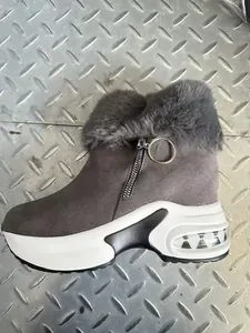 Side view detail of grey faux fur winter wedge boot featuring platform sole and zipper.