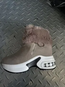 Detailed side view of khaki platform snow boot with faux fur collar and side zipper closure