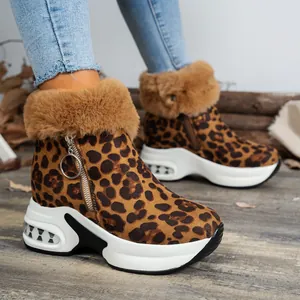 Close-up of leopard print snow boots with faux fur trim and chunky platform soles